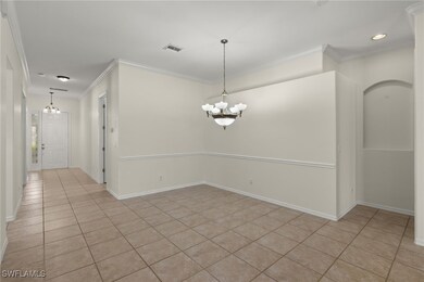 Unfurnished room featuring a notable chandelier, l