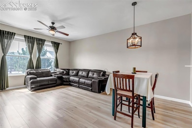 Living area with light wood-style floors, ceiling 
