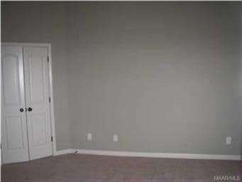 Master bedroom with double door entry to Master ba