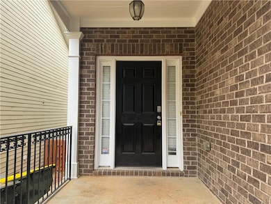 Doorway to property with brick siding