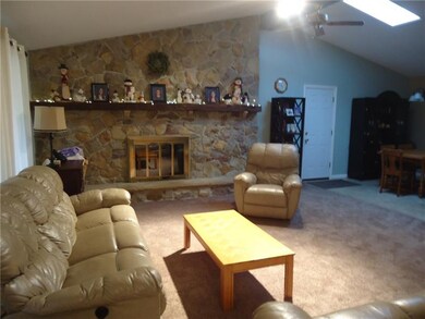 Vaulted ceiling, open floor plan with stone firepl