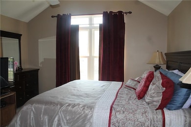 Bedroom with lofted ceiling