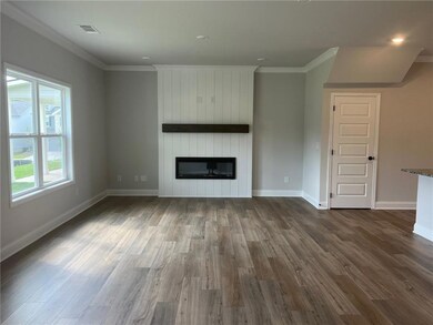 Unfurnished living room featuring ornamental molding, a fireplace, dark wood finished floors, and recessed lighting