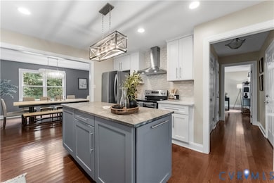 Kitchen with gray cabinets, white cabinetry, stainless steel appliances, backsplash, and recessed lighting