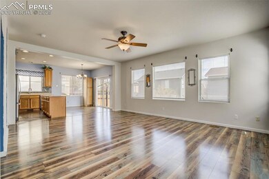 Unfurnished living room with a sink, dark wood-sty