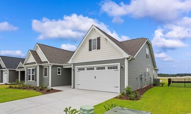 View of front of home with a front lawn and a gara