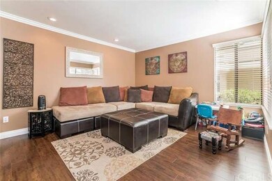 Living room with beautiful flooring, crown mouldin