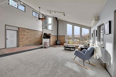 Living room with a high ceiling, a wall mounted AC