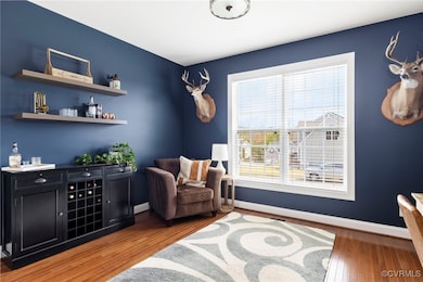 First floor bedroom or office with hardwood floor.