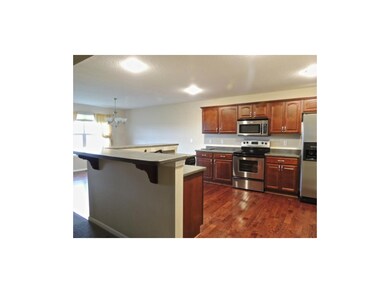 Gleaming hardwood floors and stainless steel appli