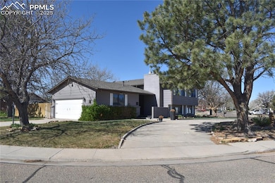 Tri-level home featuring a chimney, a garage, a fr