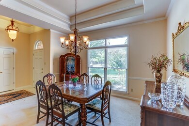 The formal dining room features a double trayed ce