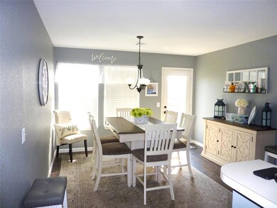 Dining area featuring a chandelier and dark wood-t