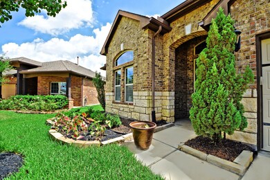 Beautiful Upgraded Stone and Brick Elevation! Upgraded Front Coach Light Fixtures to welcome you home!  Amazing 8 Foot Front Door Mahogany with Custom Cut Lead Glass Inserts!