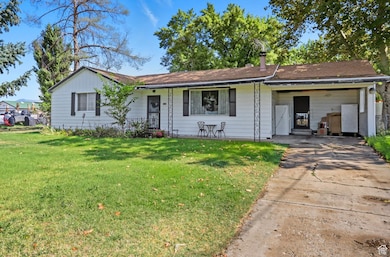Ranch-style house with a front yard and concrete driveway