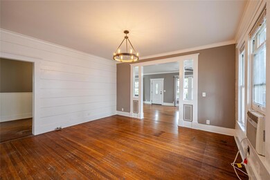 Dining room featuring a chandelier, crown molding, and dark hardwood / wood-style flooring