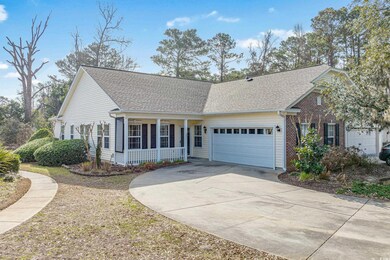 View of front of home with a garage and a porch