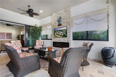 Living room featuring stone tile floors, a ceiling fan, healthy amount of natural light, and recessed lighting