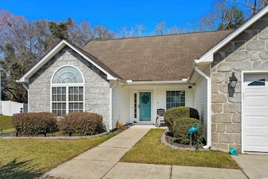Entrance to property featuring a garage, stone sid