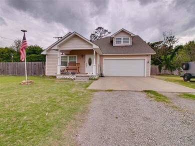 View of front of home featuring a garage, covered 