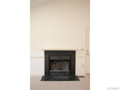 The wood fireplace in the Living Room has a mantle
