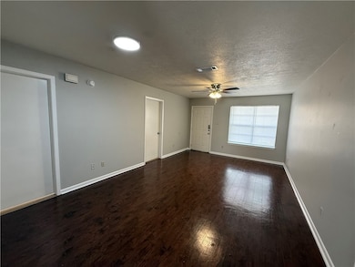 Spare room with dark wood finished floors and a textured ceiling