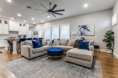 Living room with ceiling fan, a wealth of natural 