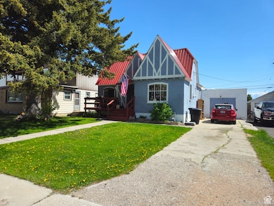Tudor home with concrete driveway and a front lawn