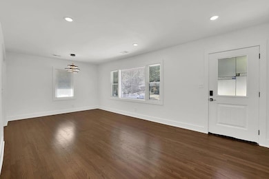 Entrance foyer featuring recessed lighting, dark wood-style flooring, and a chandelier