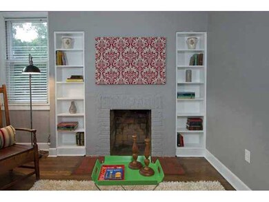 The living room includes built-in bookcases flanki