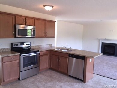 Kitchen with view to Great Room and Gas Fireplace