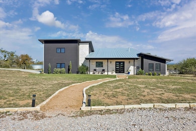 View of front of home with a porch, a front lawn,