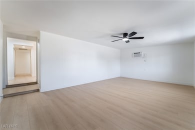 Spare room with ceiling fan and light wood-style f
