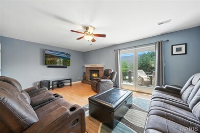 Family Room with woodburning fireplace and slider to large deck