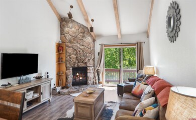 Main living area with river rock fireplace