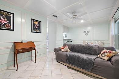 Living room with coffered ceiling, a decorative w