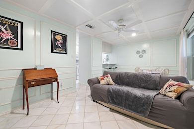Living room with coffered ceiling, a decorative w