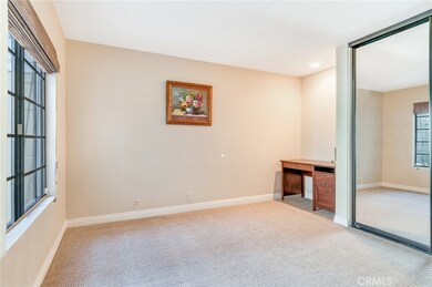 Front Bedroom with Desk Niche and Mirrored Closet Doors
