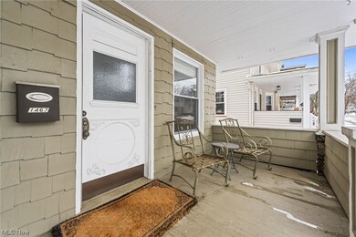 View of exterior entry with a porch