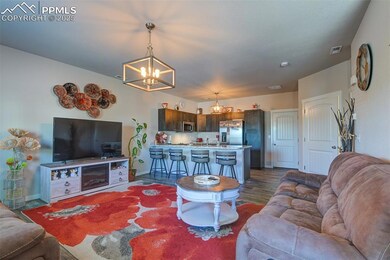 Living area with a chandelier and wood finished floors