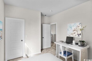 Office space with baseboards and light colored car