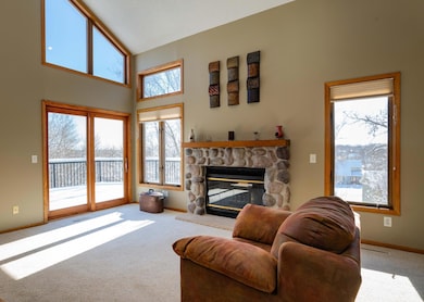 The main floor Living Room boasts soaring vaulted ceilings and several east and south facing windows which focus on the tree top views of the city and private backyard.  The natural stone wood burning fireplace makes for a warm and cozy atmosphere.