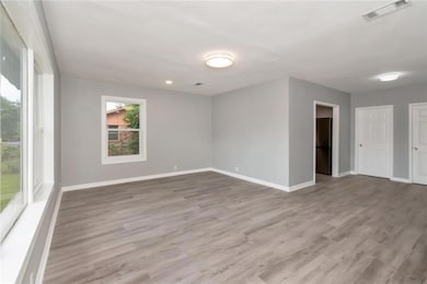 Spare room with baseboards and wood finished floors