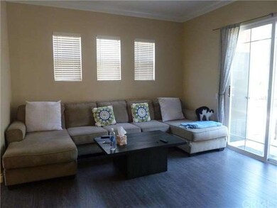 Spacious living room with wood laminate flooring.