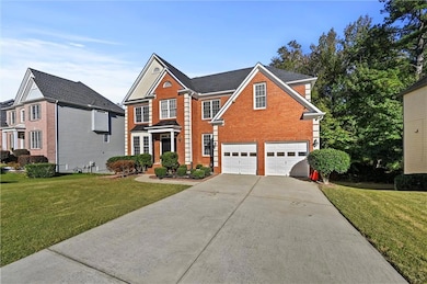 Traditional-style house with driveway, brick siding, a garage, and a front lawn