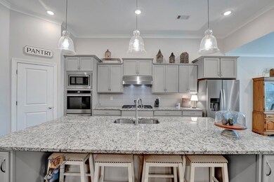 Kitchen with tasteful backsplash, ornamental moldi