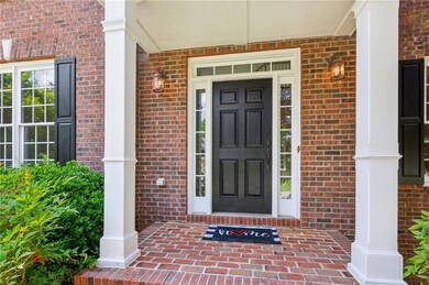 Entrance to property featuring covered porch and b