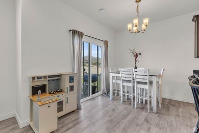 Dining space featuring light wood finished floors and a chandelier