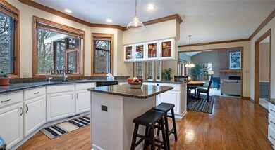 Kitchen with white cabinets, granite tops, huge wi