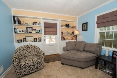 Built in shelves and door leading to covered porch